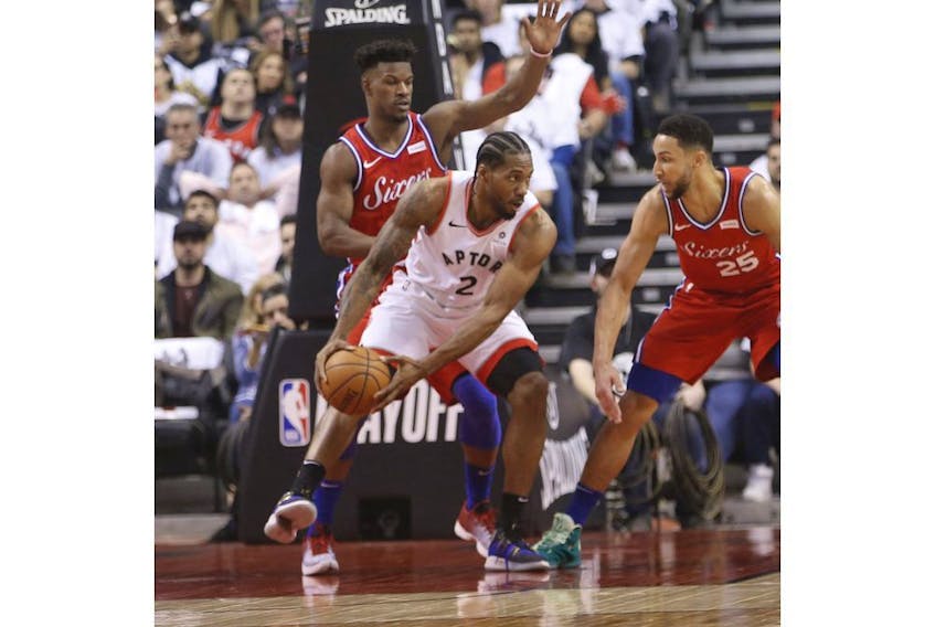 Toronto Raptors Kawhi Leonard SF (2) guarded by Philadelphia 76ers Ben Simmons PG (25) during the first half in Toronto, Ont. on Sunday May 12, 2019.