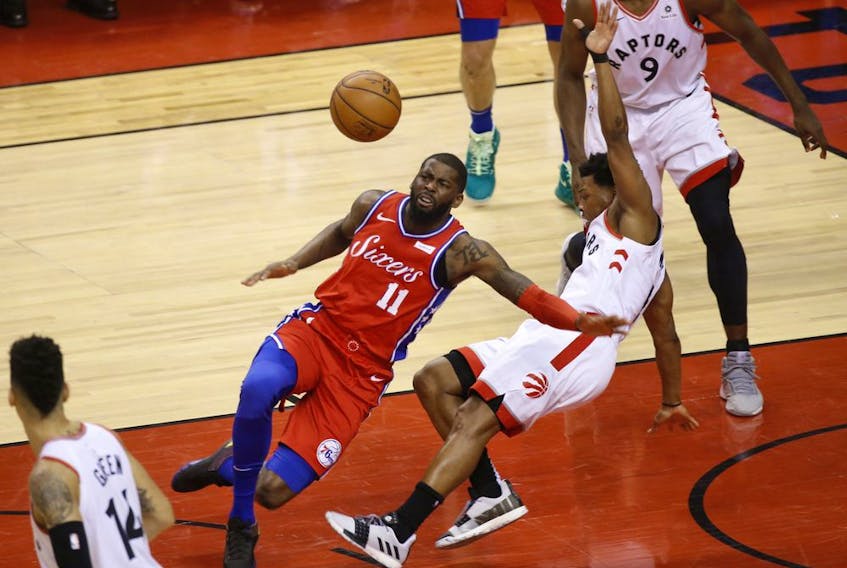 Philadelphia 76ers James Ennis III SF (11) crashes into Toronto Raptors Kawhi Leonard SF (2) during the third quarter in Toronto, Ont. on Sunday, May 12, 2019