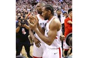 Toronto Raptors Kawhi Leonard SF (2) is congratulated by his teammate Pascal Siakim after the game in Toronto, Ont. on Sunday, May 12, 2019
