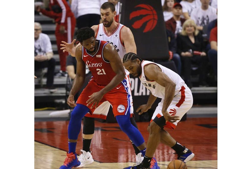 Toronto Raptors Kawhi Leonard SF (2) steals the ball from Philadelphia 76ers Joel Embiid C (21) during the first half in Toronto, Ont. on Sunday May 12, 2019. Jack Boland/Toronto Sun/Postmedia Network