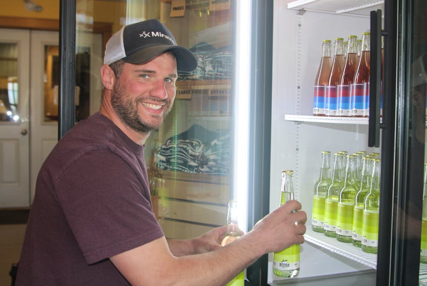 William Spurr restocks the cooler with hard cider at Spurr Brothers Farms in Melvern Square.
