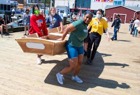 Mount Saint Vincent's Asia Bannister along with fellow university students and participants in the Two-Eyed Seeing Project Camp carry a Bevin's skiff from CSS Acadia on Friday, May 13, 2022. 
Ryan Taplin - The Chronicle Herald