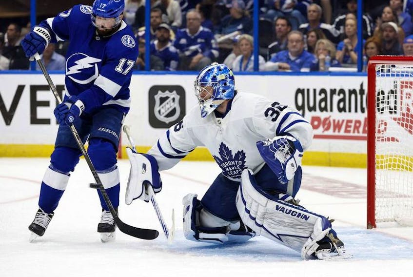 May 12, 2022; Tampa, Florida, USA; Toronto Maple Leafs goaltender Jack Campbell makes a save as Tampa Bay Lightning left wing Alex Killorn goes after the puck during the third period of game six of the first round of the 2022 Stanley Cup Playoffs at Amalie Arena. 