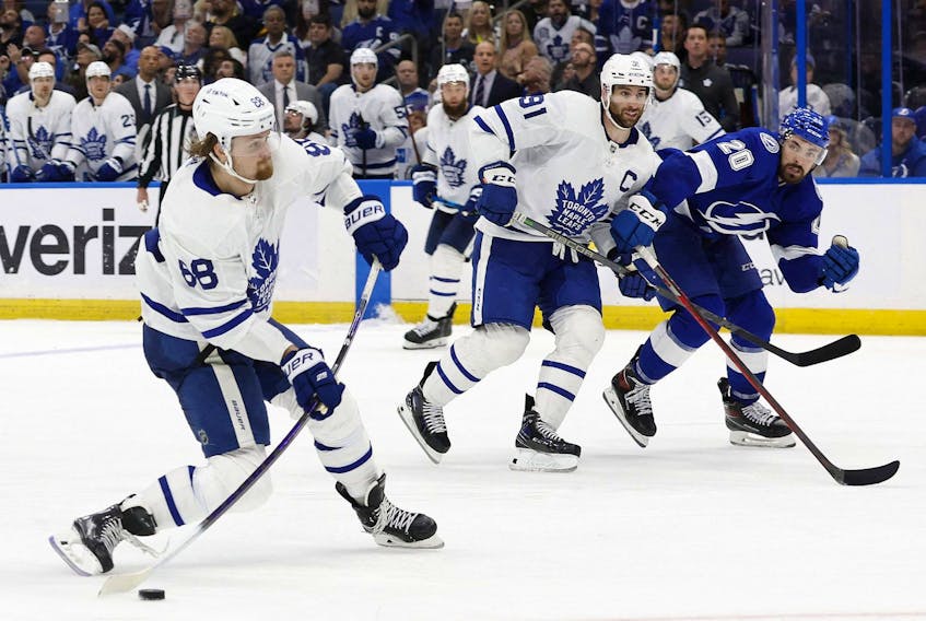 Toronto Maple Leafs right wing William Nylander, left, shoots against the Tampa Bay Lightning during overtime of Game 6 of the first round of the 2022 Stanley Cup Playoffs at Amalie Arena in Tampa, Fla., May 12, 2022.