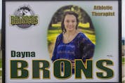  Green and yellow ribbons and a photograph of athletic therapist Dayna Brons along the boulevard on the road to Elgar Petersen Arena before the Humboldt Broncos home opener game on Sept. 12, 2018.