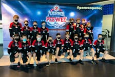 The Pownal under-13 AAA team poses around a sign for the 62nd Quebec international pee-wee hockey tournament in Quebec City. The Pownal squad had a strong showing on the ice and a great experience off the ice. Team members are, front row, from left, Cayde Hunter, Blake Hartman, Lauchie McCabe, Dylan Smith, Connor Cameron, Campbell Dunne, Colin MacCormac, Blake MacDonald and Freddie Rodgerson. Back row, from left, are Ryan Doyle, Jaxen Bowring, Donovan McGuirk, Brett Pierce, Max McGuigan, Hugh MacDonald, Carsen Pierce and Griffin Belik. Contributed