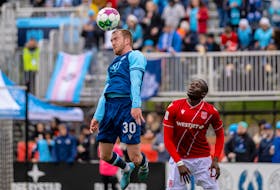 HFX Wanderers defender Colin Gander jumps to head the ball in front of Calvary FC midfielder Jean-Aniel Assi during Canadian Premier League action Sunday afternoon at the Wanderers Grounds in Halifax. - TREVOR MacMILLAN / HFX WANDERERS