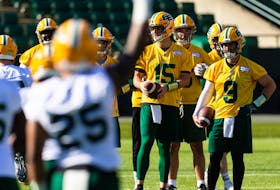 Quarterbacks Taylor Cornelius (15) and Nick Arbuckle (9) warm up during the first day of Edmonton Elks training camp at Commonwealth Stadium in Edmonton on Sunday, May 15, 2022.