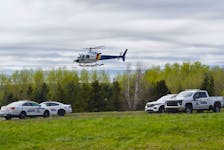 An RCMP helicopter and numerous police cars could be seen on a lot on the side of the Granton-Abercrombie Road in Pictou County May 16, where a search for a child and man was underway. Both were located and the child is safe and healthy.