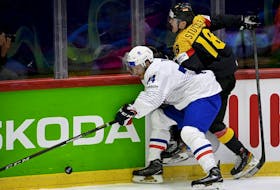 France's defender Thomas Thiry (left) and Germany's forward Tim Stuetzle vie for the puck during the IIHF Ice Hockey World Championships 1st Round group A match between France and Germany at the Helsinki ice Hall in Helsinki, Finland, on May 16, 2022. 