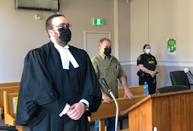 Robert Layman (centre) stands behind his lawyer, Robert Hoskins, as Justice Vikas Khaladkar (not pictured) enters the courtroom at the start of Layman's trial at Newfoundland and Labrador Supreme Court in St. John's May 9.