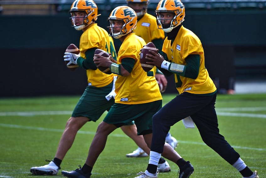 Quarterbacks Kai Locksley (10), Tre Ford (2) and Mike Beaudry (14) drop back to pass during the first day of Edmonton Elks rookie camp at Commonwealth Stadium in Edmonton on Wednesday, May 11, 2022.