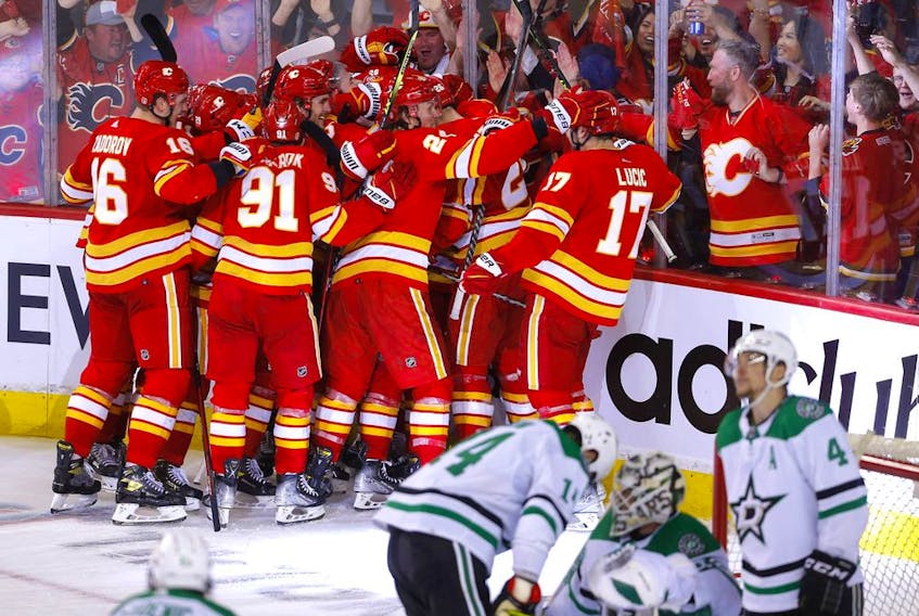  The Calgary Flames celebrate after Johnny Gaudreau’s overtime winner on Sunday.