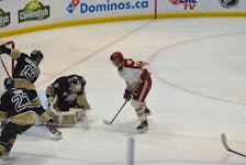 Charlottetown Islanders goaltender Franky Lapenna makes sure there is no rebound after making a save against the Acadie-Bathurst Titan on May 15. The Titan’s Nolan Forster, 77, looks for a rebound while Lapenna is supported by teammates Jérémie Biakabutuka, 13, and Jarrett Todd, 23. The Islanders won the opening game of the best-of-five series 4-1. Jason Simmonds • The Guardian