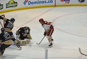 Charlottetown Islanders goaltender Franky Lapenna makes sure there is no rebound after making a save against the Acadie-Bathurst Titan on May 15. The Titan’s Nolan Forster, 77, looks for a rebound while Lapenna is supported by teammates Jérémie Biakabutuka, 13, and Jarrett Todd, 23. The Islanders won the opening game of the best-of-five series 4-1. Jason Simmonds • The Guardian