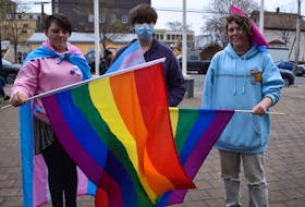 From left, Alexandra Pace, Emily Kinnear, and Liam Burke hold flags during a flag raising ceremony at the Cape Breton Regional Municipality city hall in Sydney on Tuesday for International Day Against Homophobia, Transphobia and Biphobia. The day was created in 2004 to draw attention to the violence and discrimination experienced by lesbian, gay, bisexual, transgender, intersex people and all other people with diverse sexual orientations, gender identities or expressions, and sex characteristics. The day is now celebrated in more than 130 countries, including 37 where same-sex acts are illegal. May 17 was specifically chosen to commemorate the World Health Organization’s decision in 1990 to declassify homosexuality as a mental disorder. CAPE BRETON POST PHOTO.