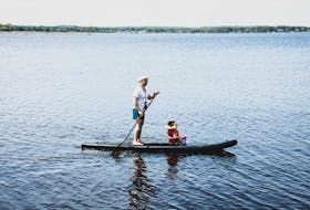 Terry Arsenault and his daughter, Maia, take a ride on one of Seacow Outdoors' paddleboards – the business started up by Arsenault alongside his friend, James Shea.