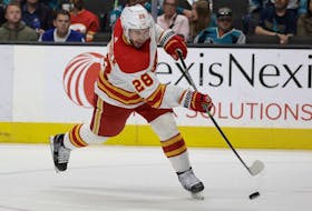 Calgary Flames centre Elias Lindholm, pictured firing a goal-scoring shot against the San Jose Sharks on April 7, 2022, has reached the 40-goal mark this season.