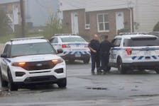 Halifax Regional Police officers confer after opening up having Road near Sylvia as they investigate overnight stabbing in Halifax Tuesday, May 17, 2022