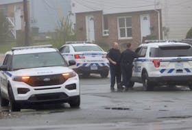 Halifax Regional Police officers confer after opening up having Road near Sylvia as they investigate overnight stabbing in Halifax Tuesday, May 17, 2022