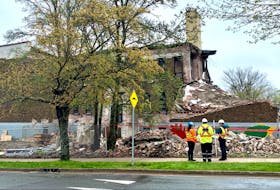A provincial labour department investigator was on the scene Tuesday after part of a building demolished collapsed onto the sidewalk outside the demolition site. There were no injuries.