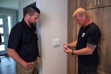 Mike Holmes discusses Swidget smart switches with Chris Adamson, on Holmes Family Rescue. 