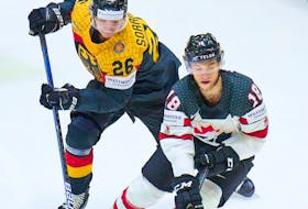 Germany's Samuel Soramies fights for the puck against Canada's Dawson Mercer at the IIHF World Championship in Helsinki, Finland, May 13, 2022.