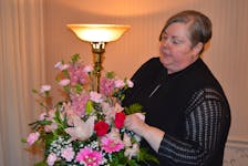 Jodi Swan, who is now certified in death education and grief counselling, works with a flower arrangement on May 13 at MacLean Funeral Home Swan Chapel in Charlottetown. Dave Stewart • The Guardian