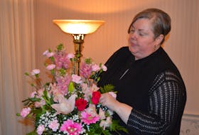 Jodi Swan, who is now certified in death education and grief counselling, works with a flower arrangement on May 13 at MacLean Funeral Home Swan Chapel in Charlottetown. Dave Stewart • The Guardian