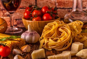 Products for cooking - pasta, tomatoes, garlic, olive oil and red wine. Selective focus.  Mariolina Koller-Fanconi: "Italy is a fascinating country thanks to its geographical position in the Mediterranean, its history and its inhabitants, who warmly welcome visitors." 123RF Stock photo