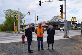 A new pedestrian crossing on East River Road in New Glasgow will go live on May 19. From left are: Const. Ken Macdonald, Civil Engineering Technologist Adam Langille and Active Living Manager Veronica Deno.