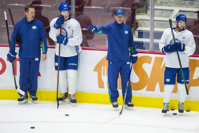Canucks' assistant coaches Kyle Gustafson  (left) and Brad Shaw with players at team practice at Rogers Arena in Vancouver, BC Wednesday, October 6, 2021.



Photo by Jason Payne/ PNG)

(For story by Patrick Johnston) ORG XMIT: canucks [PNG Merlin Archive]