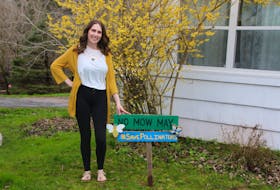 Jessica Frenette has a “No Mow May” sign on the lawn of her home in Truro. She let things grow for a while so pollinators can find flowering plants. LYNN CURWIN 