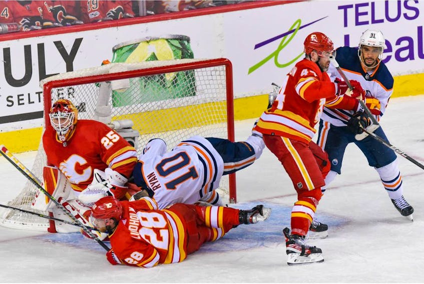  Calgary Flames Elias Lindholm and Edmonton Oilers Derek Ryan crash into each other in front of Calgary Flames goalkeeper Jacob Markstrom during the third period of the first game of the second round of playoff action at Scotiabank Saddledome on Wednesday, May 18, 2022.