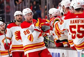  Calgary Flames defenceman Michael Stone is congratulated at the bench after scoring what ended up being the winning goal against the Anaheim Ducks at Honda Center in Anaheim on Wednesday, April 6, 2022.