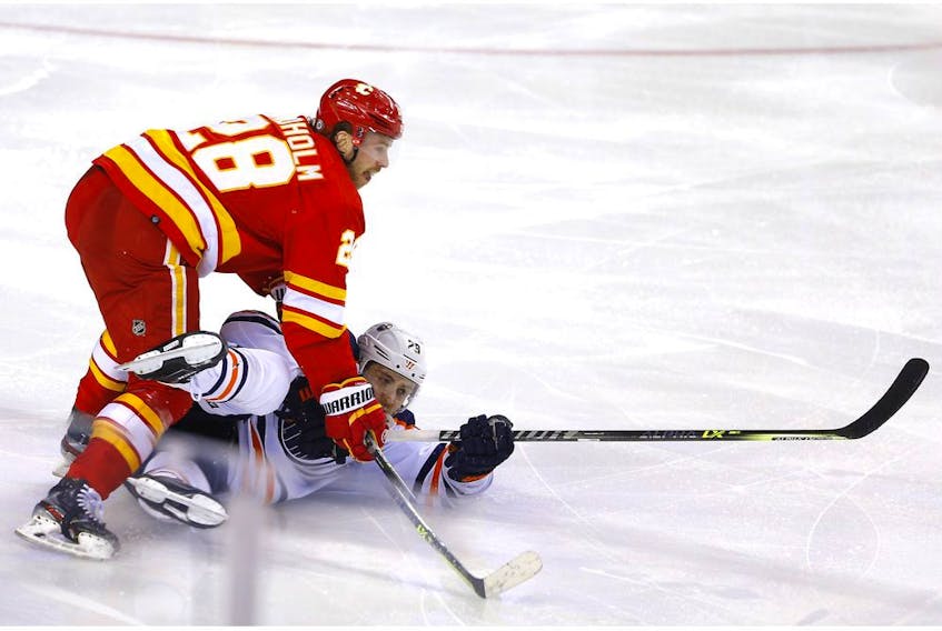 Calgary Flames Elias Lindholm Edmonton Oilers Leon Draisaitl in third period NHL action at the Scotiabank Saddledome in Calgary on Monday, March 7, 2022. 