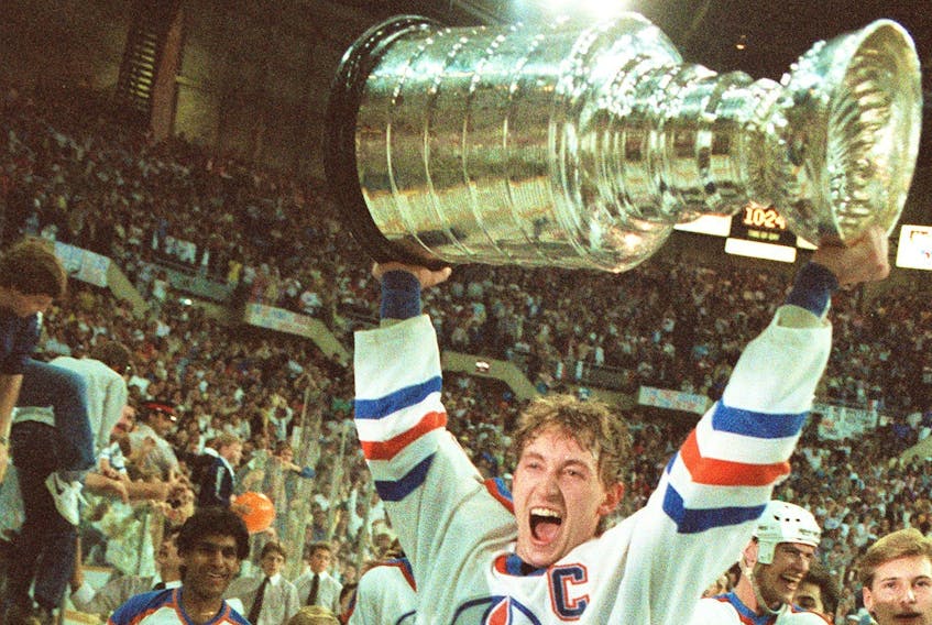 Wayne Gretzky lifting the Stanley Cup while with the Edmonton Oilers.