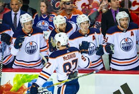  May 18, 2022; Calgary, Alberta, CAN; Edmonton Oilers center Connor McDavid (97) celebrates his goal with teammates against the Calgary Flames during the first period in game one of the second round of the 2022 Stanley Cup Playoffs at Scotiabank Saddledome.