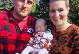 Andrew Pearson, his wife Kirstie Pearson and their baby girl Jane, at their Grand Mira South property on Thanksgiving 2021. They family have no home to live in while waiting for Nova Scotia Power to finish hooking up the power lines to their new home; a process started a year ago.