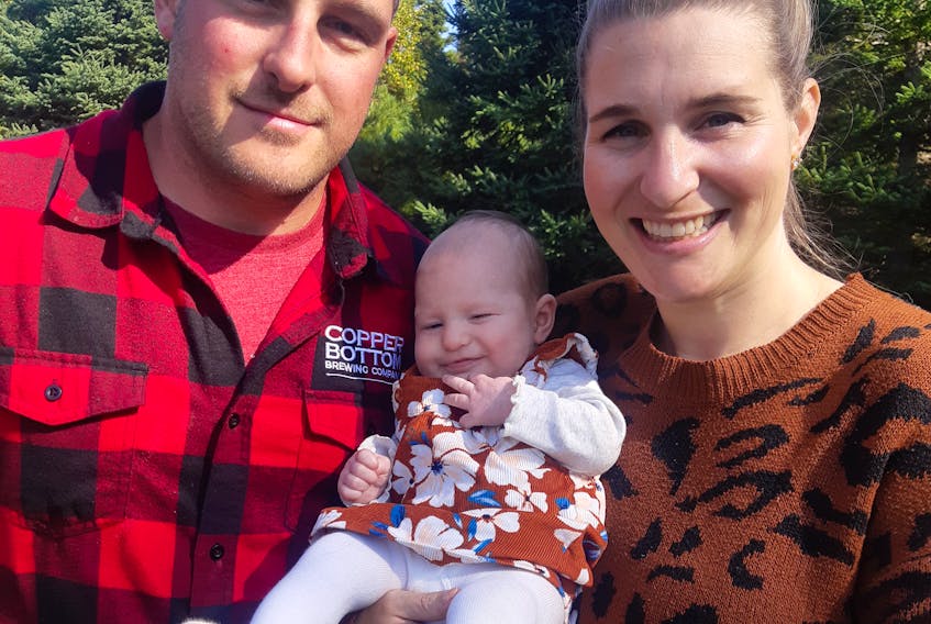 Andrew Pearson, his wife Kirstie Pearson and their baby girl Jane, at their Grand Mira South property on Thanksgiving 2021. They family have no home to live in while waiting for Nova Scotia Power to finish hooking up the power lines to their new home; a process started a year ago.