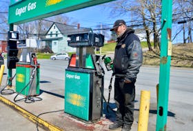 Service station employee Eugene English says motorists are not happy about how little fuel they are getting for their dollars. English, shown above at the pumps at Broadway Auto Repair in Whitney Pier, said he really sees a difference when vehicles with large capacity tanks fill up. DAVID JALA/CAPE BRETON POST
