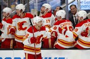  Calgary Flames center Trevor Lewis (22) celebrates with teammates — including Milan ‘Big Looch’ Lucic (No. 17) on the bench after scoring against San Jose Sharks during the first period of an NHL hockey game in San Jose, Calif., Thursday, April 7, 2022.