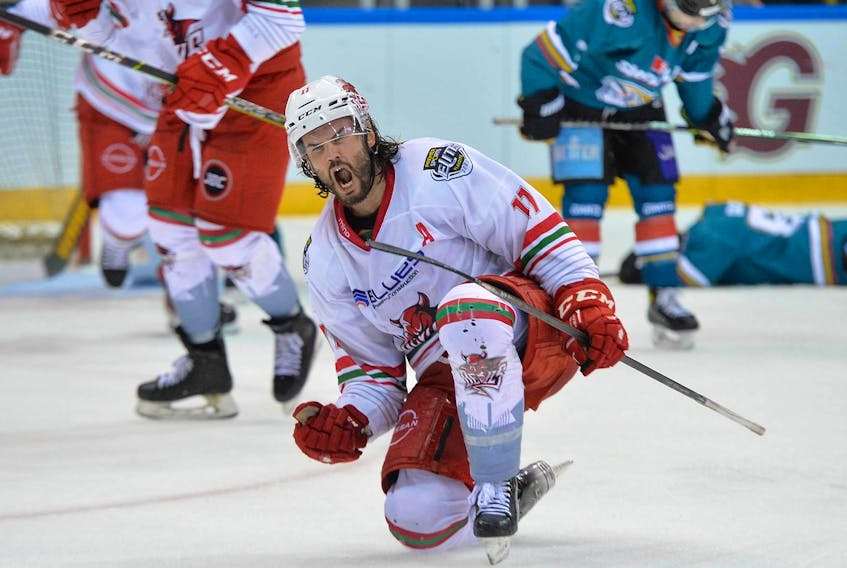 Former Cape Breton Eagle Stephen Dixon celebrates after scoring a goal in the Elite Ice Hockey League playoff championship game Sunday night. Dixon and the Cardiff Devils won the playoff title, defeating the Belfast Giants 6-3. PHOTO CONTRIBUTED/DEAN WOOLLEY, CARDIFF DEVILS.