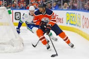  Edmonton Oilers forward Evander Kane (91) looks to make a pass in front of Vancouver Canucks defencemen Tyler Myers (57) during the third period at Rogers Place on Friday.