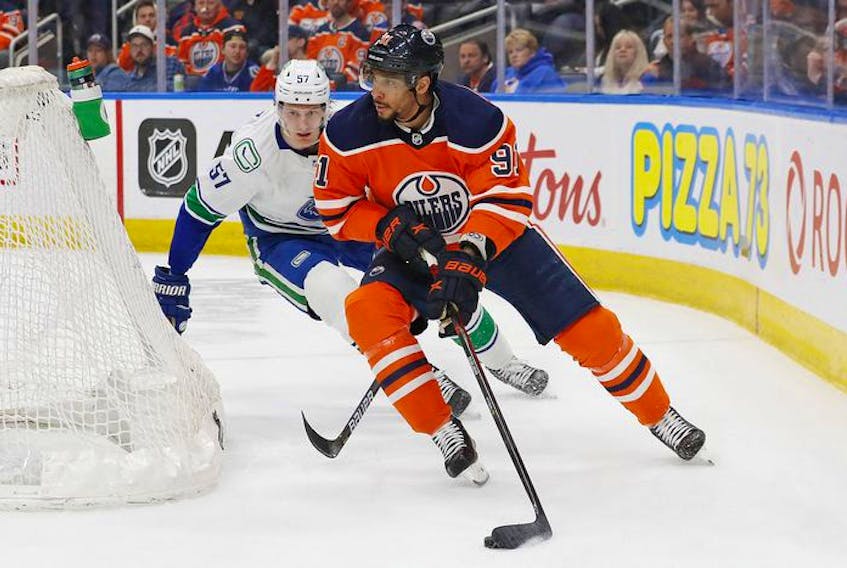  Edmonton Oilers forward Evander Kane (91) looks to make a pass in front of Vancouver Canucks defencemen Tyler Myers (57) during the third period at Rogers Place on Friday.