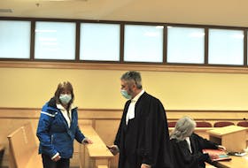Neila Blanchard of Parson’s Pond is seen talking with her lawyer, Jamie Luscombe, in the Supreme Court of Newfoundland and Labrador in Corner Brook on Monday, May 2.