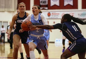 Halifax Thunder's Haley McDonald drives to the basket against a pair of Windsor Edge defenders during Maritime Women's Basketball Association action on Thursday night at Saint Mary's University. - Jodi Brown