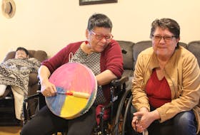 Rosie Sylliboy, right, the manager at Mawita'mk in We'koqma'q, shown with residents of the community home for L'nuk with disabilities, from left, Anna Farrell and Annie Michael, who made and painted the drum she is holding as part of the programming at Mawita'mk. Ardelle Reynolds/Cape Breton Post