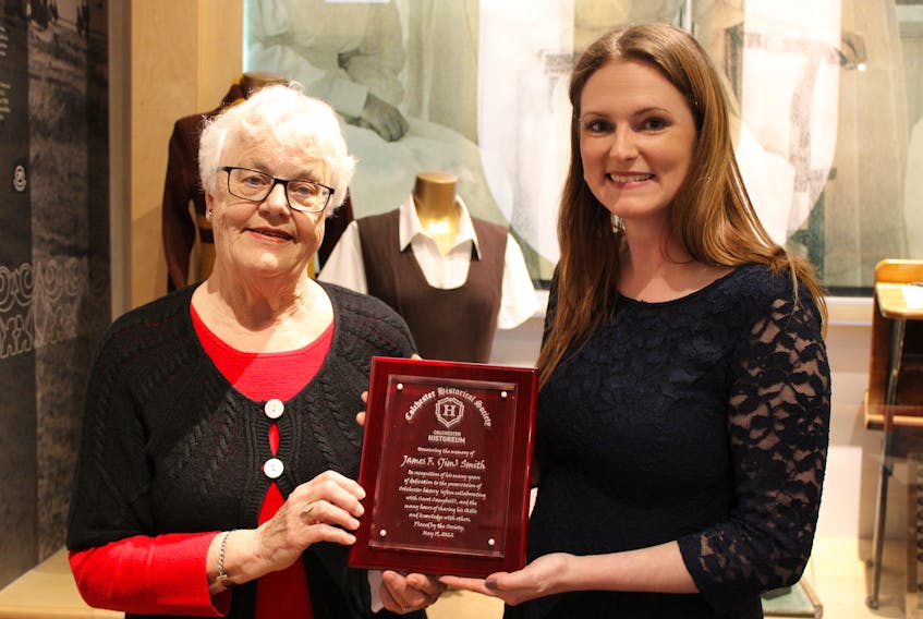 A presentation was made in memory of the late Jim Smith, a longtime volunteer at the Colchester Historeum, during Heritage Night hosted by the Colchester Historical Society. Holding a plaque in his memory are Elinor Maher and archivist Ashley Sutherland.
