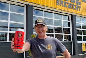 Cameron Hartley, the owner and founder of Schoolhouse Brewery, shows off his Principal Ale — his flagship pale ale that recently won a silver medal at the 2022 Canadian Brewing Awards.